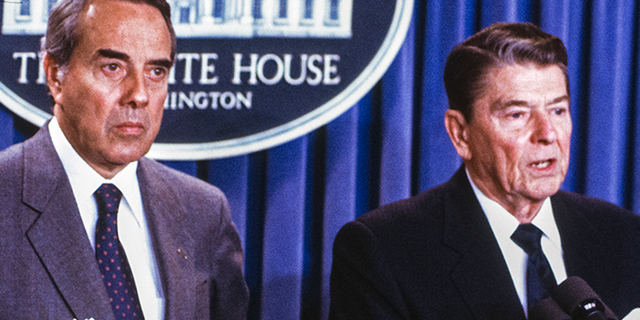 Pres. Ronald W. 里根 ([R) standing with Sen. Robert J. Dole of Kansas in the White House press briefing room. (Photo by Dirck Halstead/Getty Images)