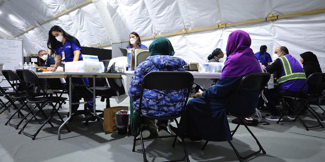 Afghan refugee women register to be seen by a doctor inside the medical tent at Liberty Village on Joint Base McGuire-Dix- Lakehurst, N.J., on Dec, 2, 2021.