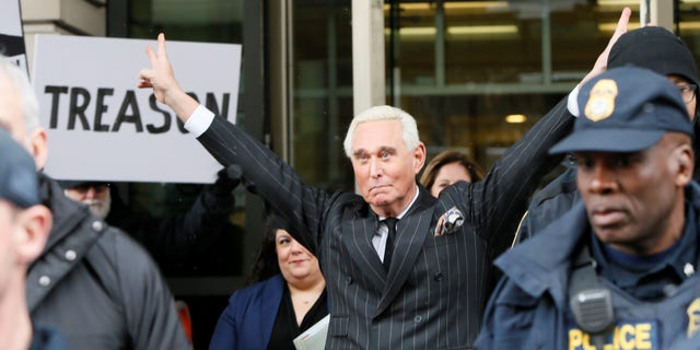Roger Stone, longtime political ally of President Trump, flashes a trademark Nixon victory gesture as he departs following a status conference in the criminal case against him brought by Special Counsel Robert Mueller at U.S. District Court in Washington, Feb. 1, 2019. 