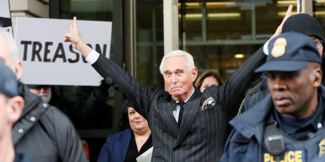 Roger Stone, longtime political ally of President Trump, flashes a trademark Nixon victory gesture as he departs following a status conference in the criminal case against him brought by Special Counsel Robert Mueller at U.S. District Court in Washington, Feb. 1, 2019. 