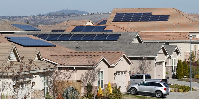 This photo taken Wednesday, Feb. 12, 2020, shows solar panels on rooftops of a housing development in Folsom, California.
