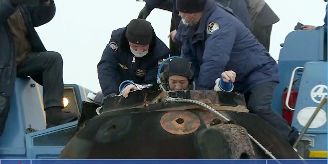 Russian space agency rescue team helps Yusaku Maezawa shortly after the landing of the Russian Soyuz MS-20 space capsule in Kazakhstan, Monday, Dec. 20, 2021.