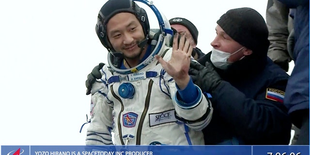 Yozo Hirano is helped from the capsule shortly after the landing in Kazakhstan, Monday, Dec. 20, 2021.