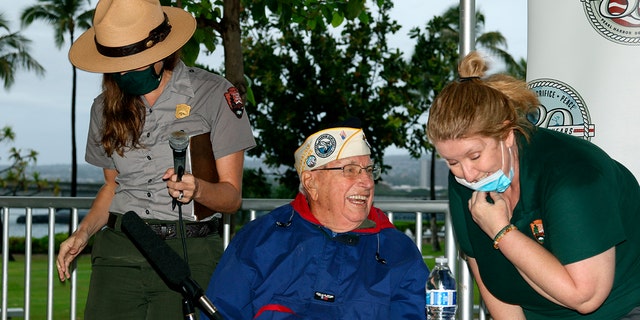 Herb Elfring speaks with National Park Service workers in Pearl Harbor, Hawaii, on Sunday, Dec. 5, 2021. 