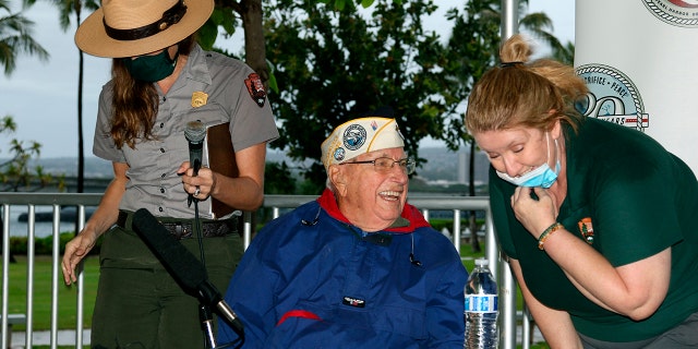 Herb Elfring speaks with National Park Service workers in Pearl Harbor, Hawaii, on Sunday, Dec. 5, 2021.