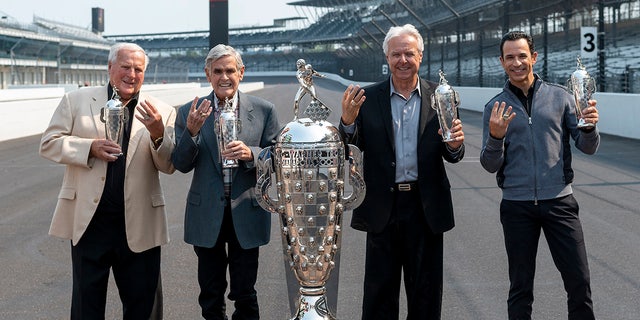 Unser (second from left) poses with four-time Indy 500 winners A.J. Foyt, Rick Mears and Helio Castroneves