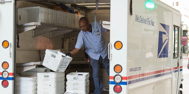 A USPS deliveryman sorting in the back of his truck in Chicago, Illinois, on Sept. 10, 2015.