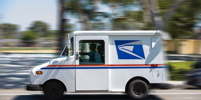 USPS truck driving in California.