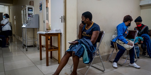 People wait to be vaccinated against COVID-19 at the Hillbrow Clinic in Johannesburg, South Africa, Monday Dec. 6, 2021. The new omicron variant appears to be driving a dramatic surge in South Africa, providing the world a glimpse of where the pandemic might be headed.