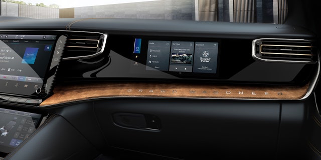 The Grand Wagoneer has a screen installed in front of the front seat passenger that can play video while the vehicle is in motion, but is filtered so that it can't be viewed from the driver's seat.