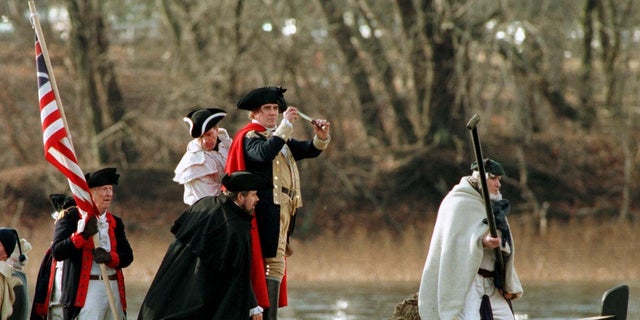 Gen. George Washington, portrayed by Bob Gerenser, 43, of New Hope, Pennsylvania, second from right, crosses the Delaware River with his troops to Trenton, New Jersey, from the Washington Crossing Historic Park in Pennsylvania, during a past crossing. 