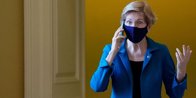 U.S. Senator Elizabeth Warren (D-MA) speaks on the phone before the start of the Senate Democrats' weekly policy luncheon at the U.S. Capitol building in Washington, U.S., December 14, 2021.