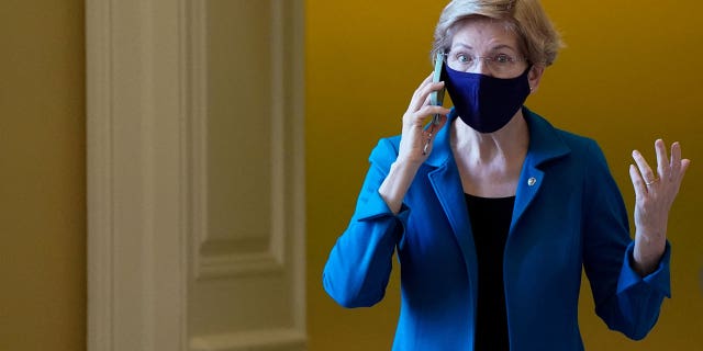 U.S. Senator Elizabeth Warren (D-MA) talks on the phone before the start of the Senate Democrats weekly policy lunch at the U.S. Capitol building in Washington, U.S., December 14, 2021.