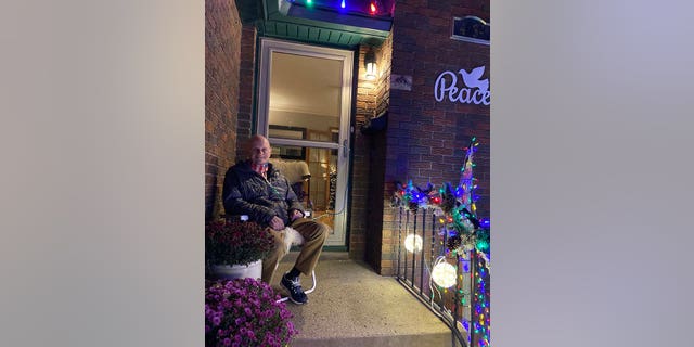 Dale Marks sitting in front of his home in Des Moines, Iowa. 