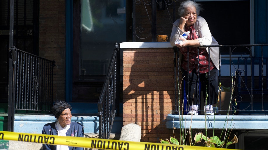 Elders watch from a porch as police officers interact with youth from the community during a block party on Sunday October 5, 2019 at the site of the August Police shooting and hours long stand off that followed, in the Nicetown-Tioga section of Philadelphia, PA. (Photo by Bastiaan Slabbers/NurPhoto)