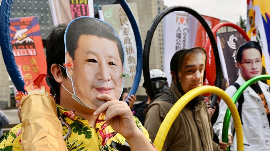 man (L) wearing a face mask with the image of China's President Xi Jinping 