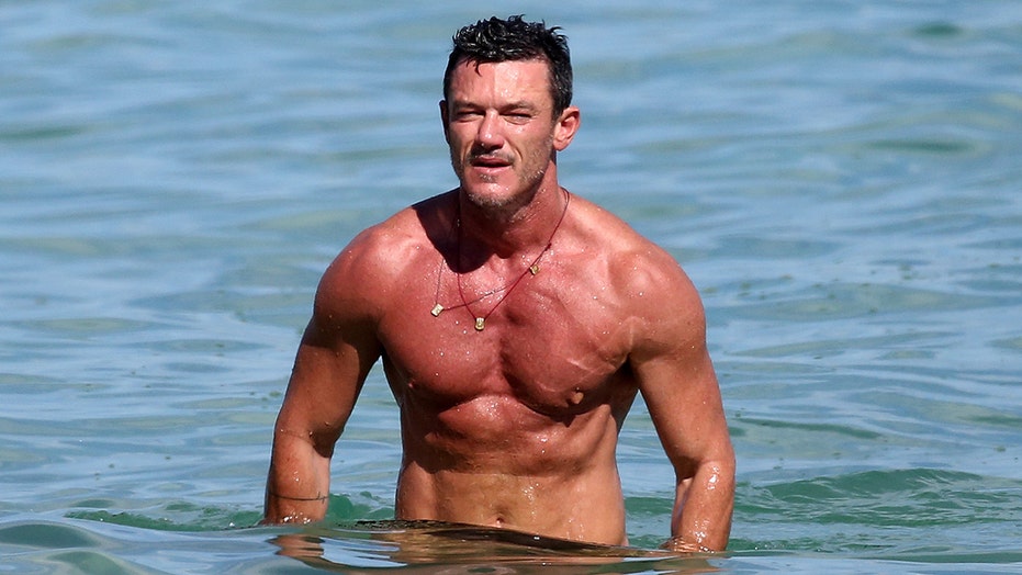 Luke Evans shows off ripped abs on the beach in Miami