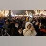 Spectators gather at the boulevard Unter den Linden near the Brandenburg Gate in Berlin, Germany, Friday, Dec. 31, 2021.
