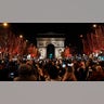 People celebrate the New Year's Eve on the Champs Elysees avenue, in Paris, Friday, Dec. 31, 2021.