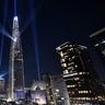 Beam lights are projected from the 123-storey Lotte World Tower skyscraper during a countdown lighting show to celebrate the New Year in Seoul on January 1, 2022.