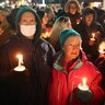 People attend a vigil downtown to honor those killed and wounded during the recent shooting at Oxford High School on December 03, 2021 in Oxford, Michigan. Four students were killed and seven others injured on November 30, when student Ethan Crumbley allegedly opened fire with a pistol at the school. Crumbley has been charged in the shooting. Today his parents were also charged.