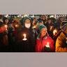 People attend a vigil downtown to honor those killed and wounded during the recent shooting at Oxford High School on December 03, 2021 in Oxford, Michigan. Four students were killed and seven others injured on November 30, when student Ethan Crumbley allegedly opened fire with a pistol at the school. Crumbley has been charged in the shooting. Today his parents were also charged.