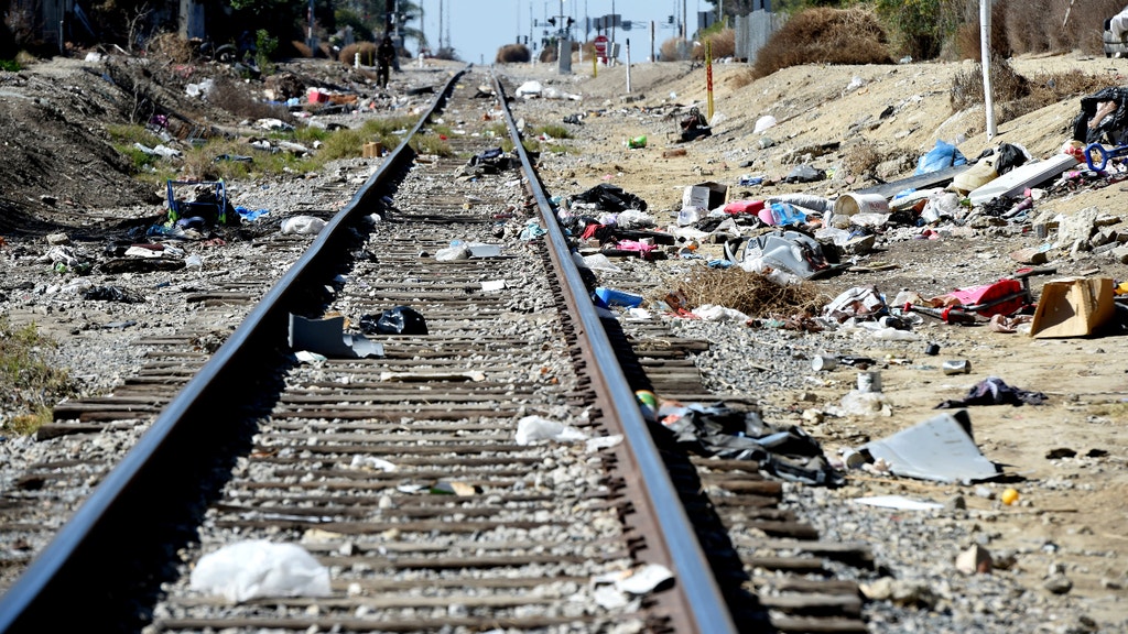 Packages litter railroad tracks as brazen thieves target MOVING trains