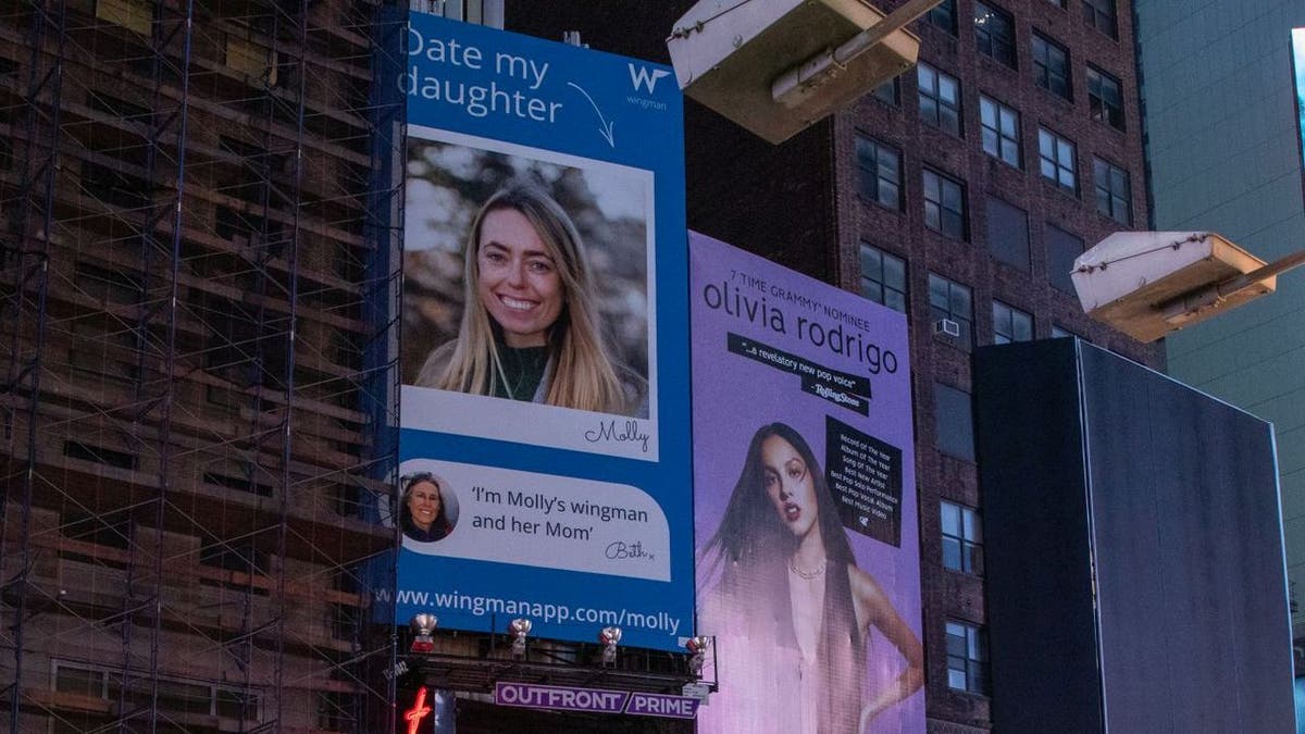 The Wingman dating app partnered with Beth Davis to get a billboard of her daughter's profile up in Times Square. The billboard features a brief intro and a photo of Beth and her daughter Molly.