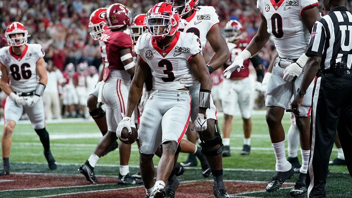 Georgia's Zamir White celebrates after running for a touchdown during the second half of the College Football Playoff championship football game against Alabama Monday, Jan. 10, 2022, in Indianapolis. 