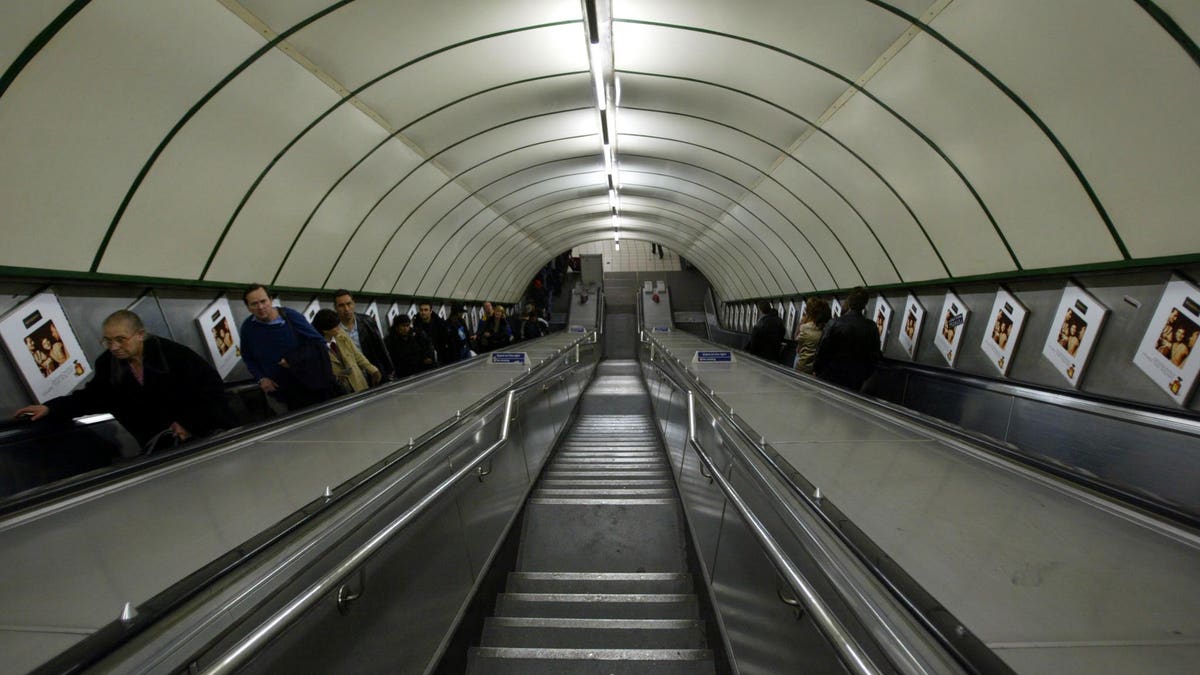 Passengers travel up the metal escalators at London's Kings Cross underground station, November 17, 2002.