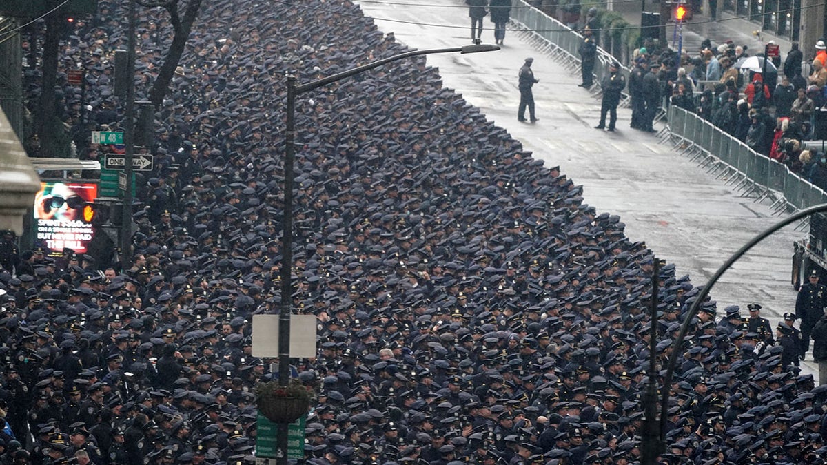 Police officers attend a funeral service for NYPD officer Jason Rivera, who was killed in the line of duty while responding to a domestic violence call, at St. Patrick's Cathedral in the Manhattan borough of New York City, U.S., January 28, 2022.