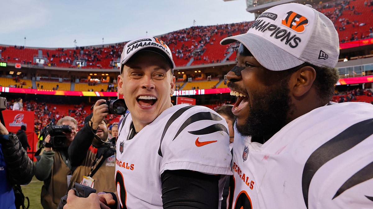 Quarterback Joe Burrow of the Cincinnati Bengals and defensive tackle Tyler Shelvin celebrate following the Bengals' overtime win against the Kansas City Chiefs in the AFC Championship Game. 