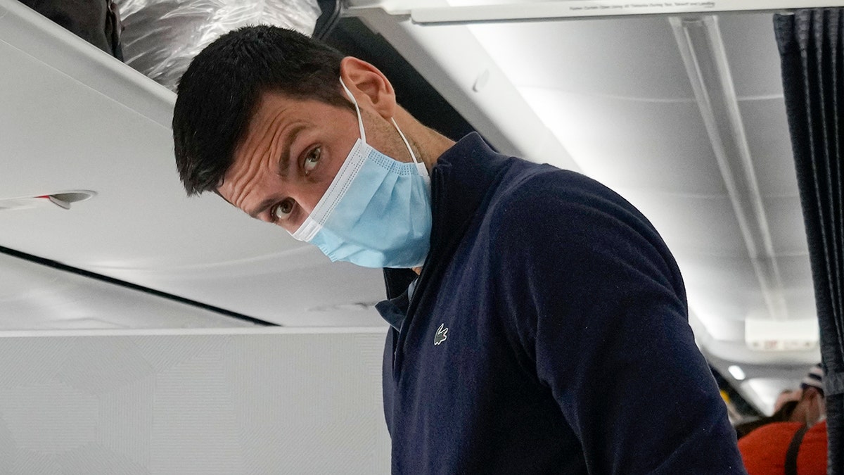 Novak Djokovic prepares to take his seat on a plane to Belgrade, in Dubai, United Arab Emirates, Monday, Jan. 17, 2022. Djokovic was deported from Australia on Sunday after losing a bid to stay in the country to defend his Australian Open title despite not being vaccinated against COVID-19.