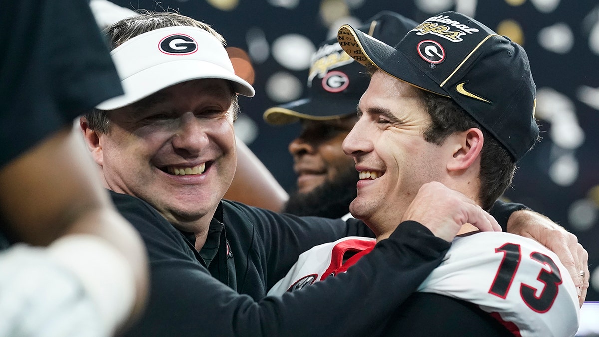 Georgia head coach Kirby Smart celebrates with Stetson Bennett after the College Football Playoff championship football game against Alabama Tuesday, Jan. 11, 2022, in Indianapolis. Georgia won 33-18.