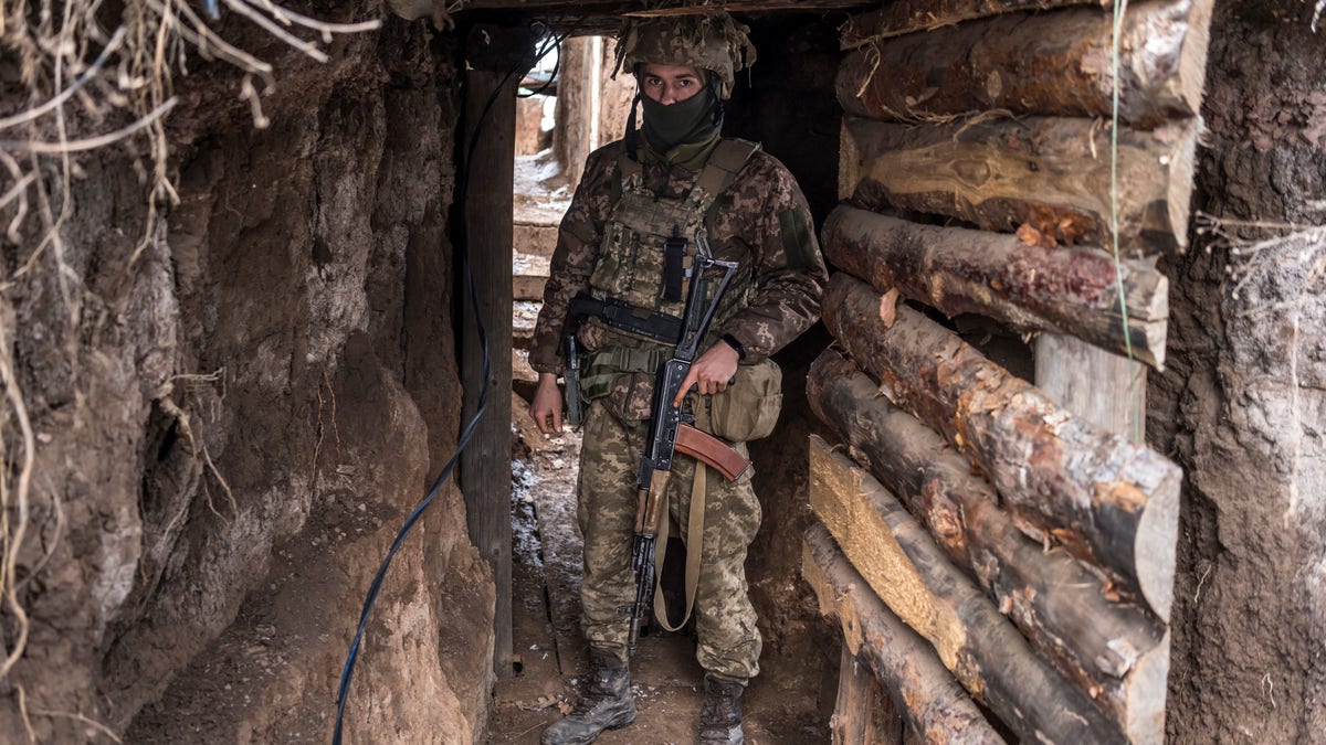 Ukrainian soldier in a trench as Russia aggresses at the border