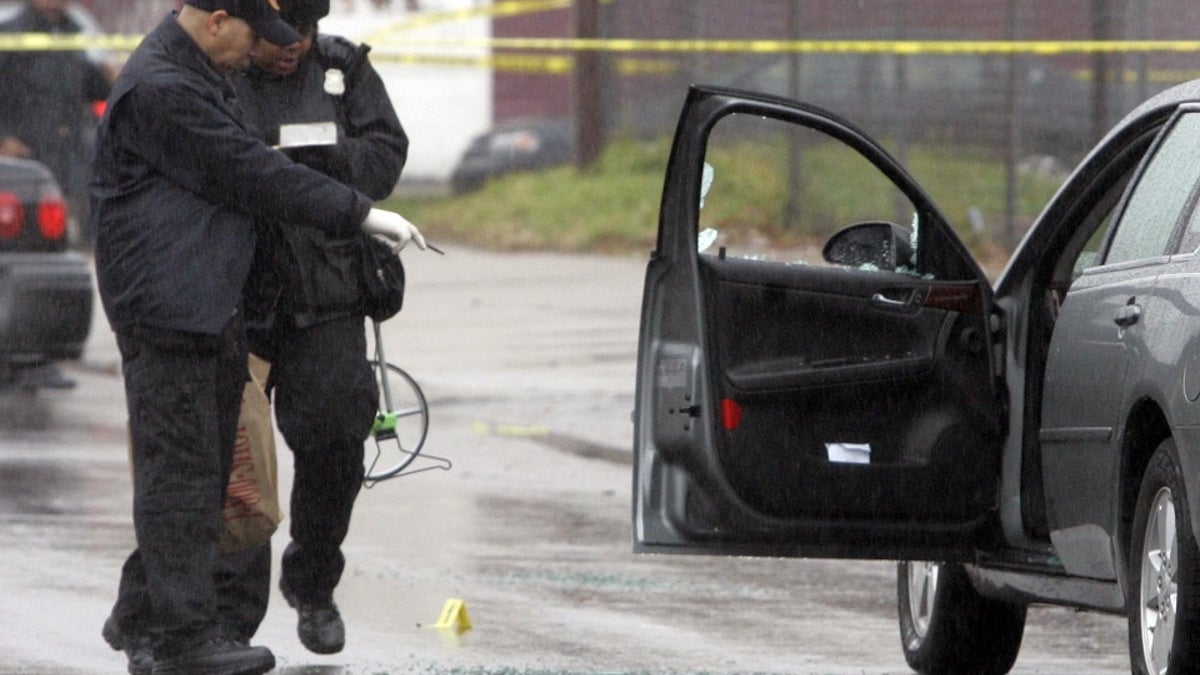 Detroit police investigate a shooting. Law enforcement leaders this week said homicides, non-fatal shootings and robberies were down in 2021.