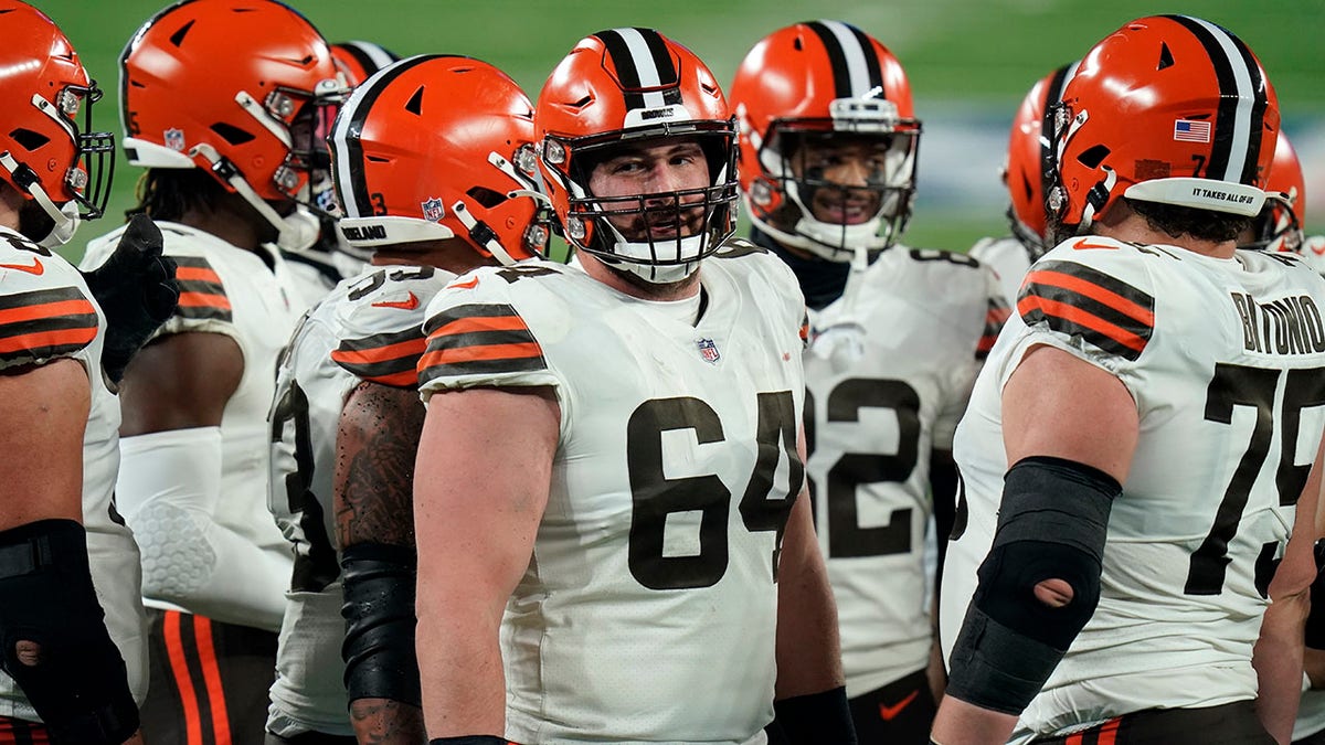 FILE - Cleveland Browns center JC Tretter (64) talks to teammates during the first half of an NFL football game against the New York Giants on Dec. 20, 2020, in East Rutherford, N.J. Tretter, the NFL Players Association president who has been pushing for daily COVID-19 testing all season, said he tested positive for the virus on Thursday, Dec. 23, 2021.
