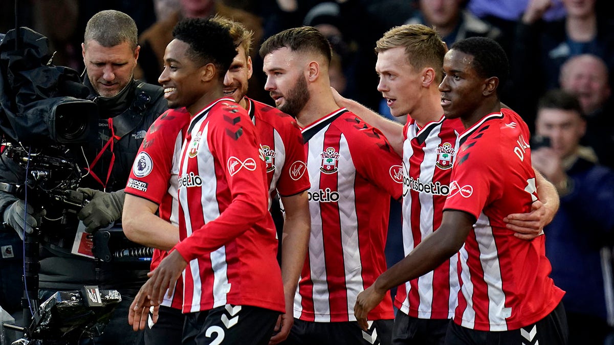 Southampton's James Ward-Prowse, second right, celebrates scoring his side's opening goal during the English Premier League soccer match between Southampton and Tottenham Hotspur, at St. Mary's Stadium, Southampton, England, Tuesday, Dec. 28, 2021.