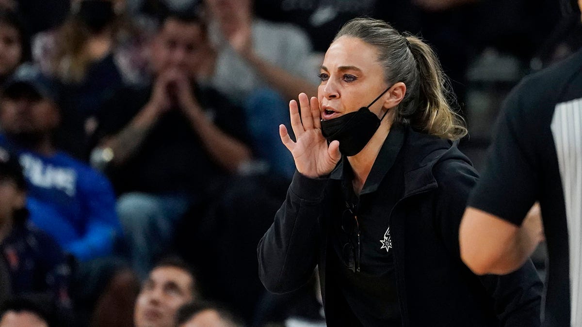 FILE - San Antonio Spurs assistant coach Becky Hammon during the first half of an NBA basketball game against the Dallas Mavericks, Friday, Nov. 12, 2021, in San Antonio. Hammon is finalizing a deal to become the next coach of the Las Vegas Aces. A person familiar with the situation confirmed the move to The Associated Press on condition of anonymity because no official announcement has been made. She’s expected to be the highest paid coach in the WNBA, earning way more than the highest paid player in the league.