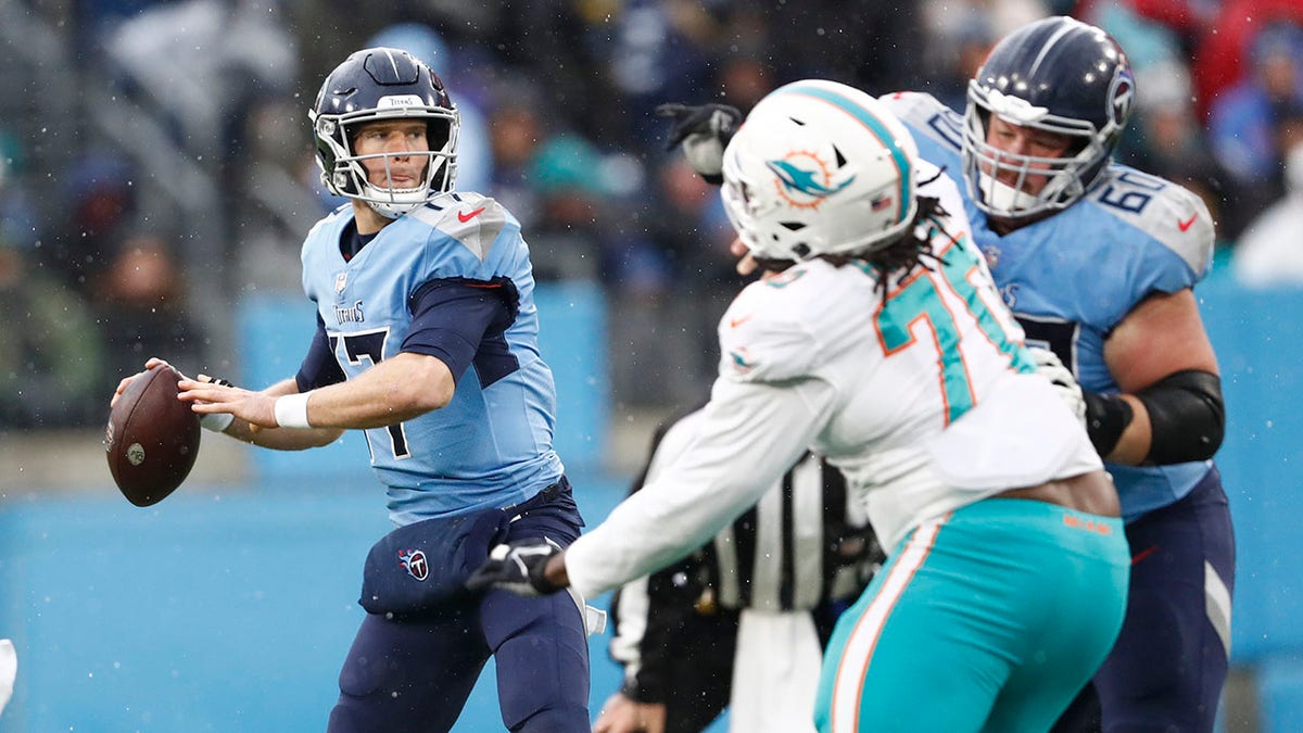 Tennessee Titans quarterback Ryan Tannehill (17) passes as he is pressured by Miami Dolphins defensive tackle Adam Butler (70) in the first half of an NFL football game Sunday, Jan. 2, 2022, in Nashville, Tenn.