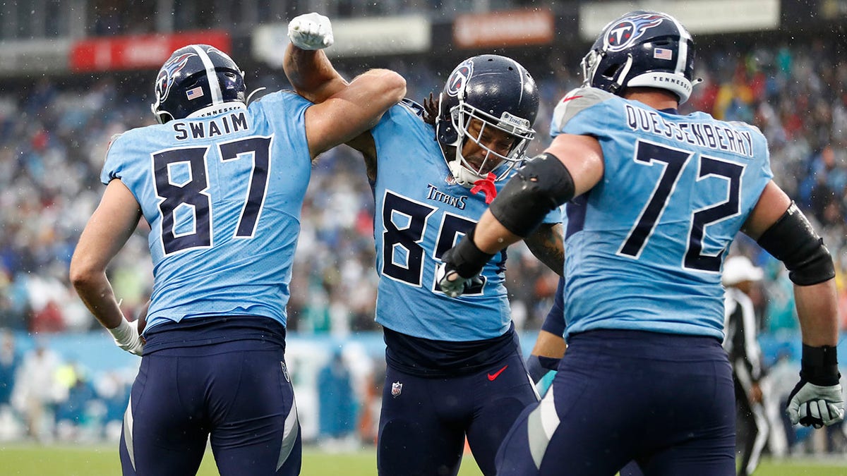 Tennessee Titans tight end Geoff Swaim (87) celebrates with MyCole Pruitt (85) after Swaim caught a touchdown pass against the Miami Dolphins in the first half of an NFL football game Sunday, Jan. 2, 2022, in Nashville, Tenn.