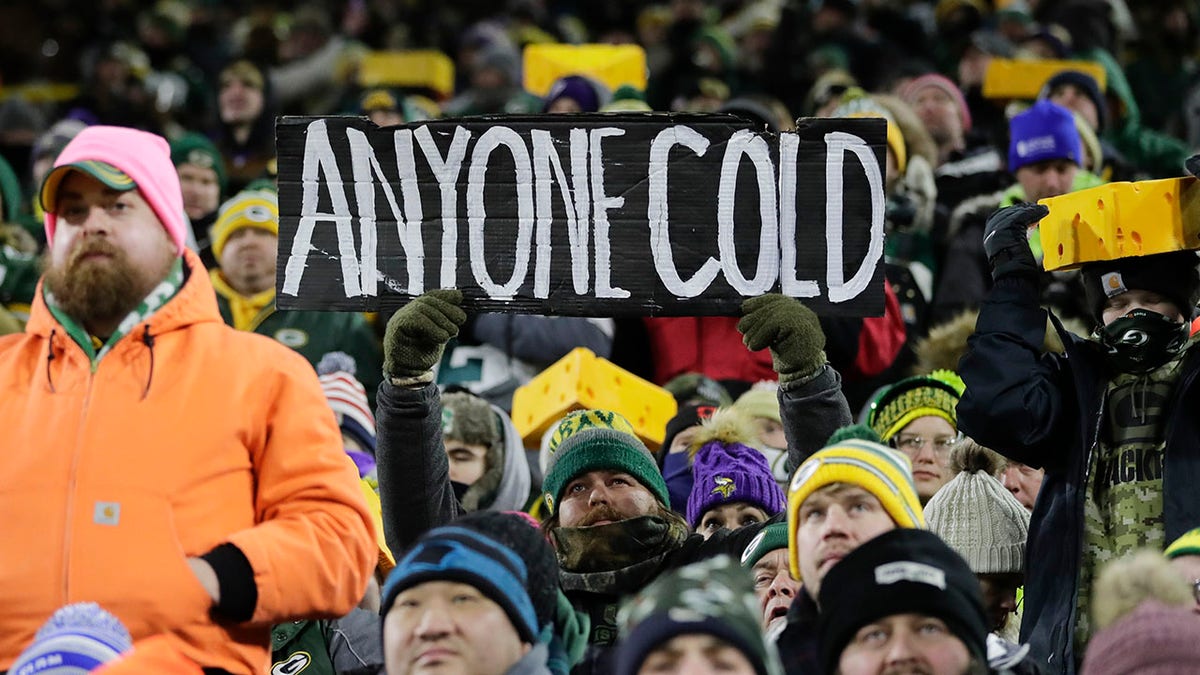 Fans watch during the first half of an NFL football game between the Green Bay Packers and the Minnesota Vikings at Lambeau Field Sunday, Jan. 2, 2022, in Green Bay, Wis.