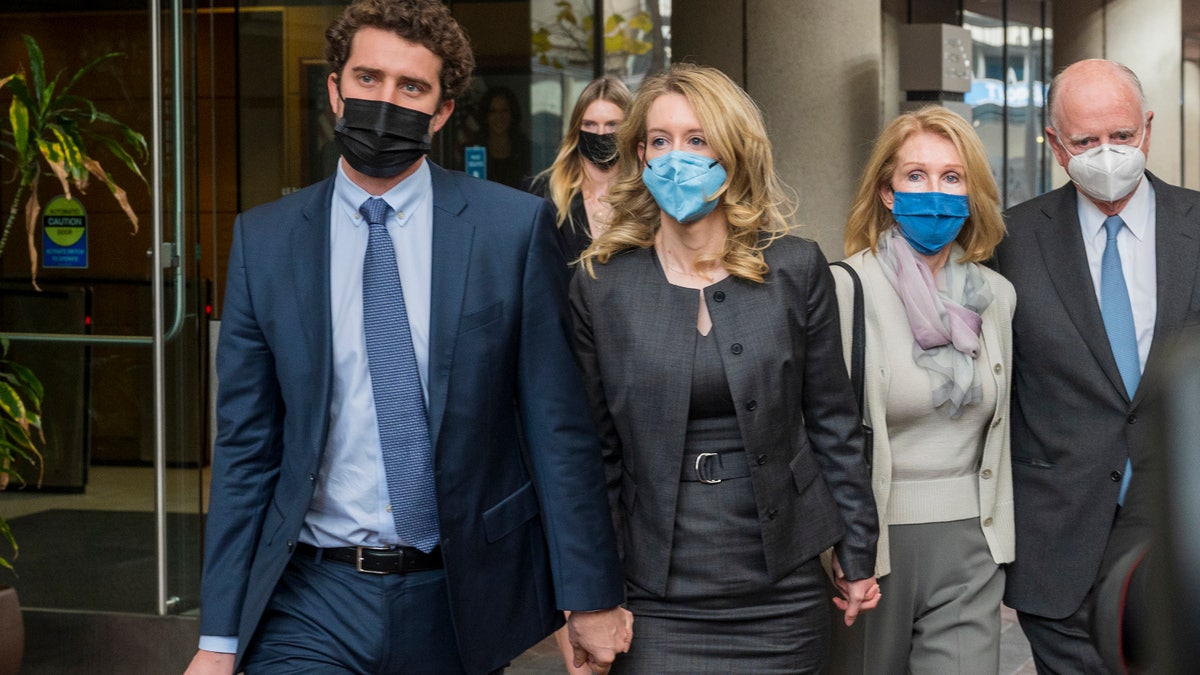 Elizabeth Holmes, center, leaves federal court in San Jose, Calif., Monday, Jan. 3, 2022. (AP Photo/Nic Coury)