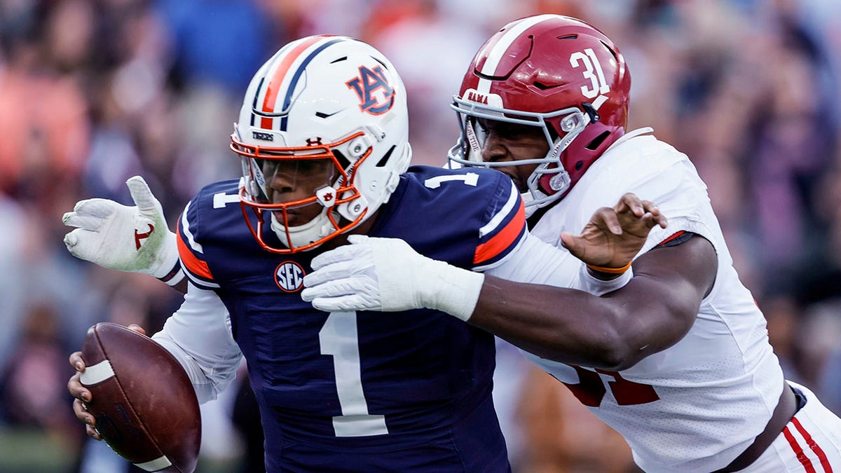 FILE - Alabama linebacker Will Anderson Jr. (31) sacks Auburn quarterback TJ Finley (1) during the first half of an NCAA college football game Saturday, Nov. 27, 2021, in Auburn, Ala. Alabama plays Georgia in the College Football Playoff national championship game on Jan. 10, 2022.