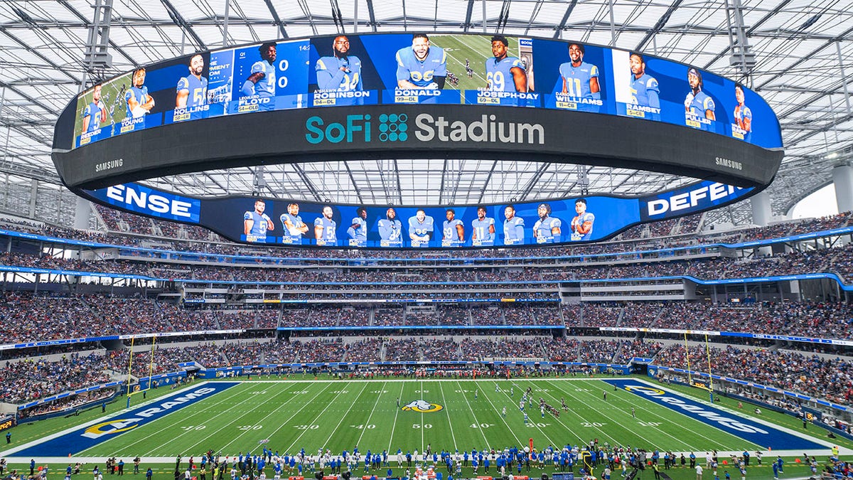 FILE - This is a general overall interior view of SoFi Stadium as the Los Angeles Rams takes on the Tampa Bay Buccaneers in an NFL football game Sunday, Sept. 26, 2021, in Inglewood, Calif. A late-season surge in COVID-19 cases had the NFL in 2021 looking a lot like 2020, when the coronavirus led to significant disruptions, postponements and changing protocols. The emerging omicron variant figures to play a role all the way through the playoffs, including the Super Bowl in Los Angeles, where California has always been aggressive with policies to combat the spread of the virus.