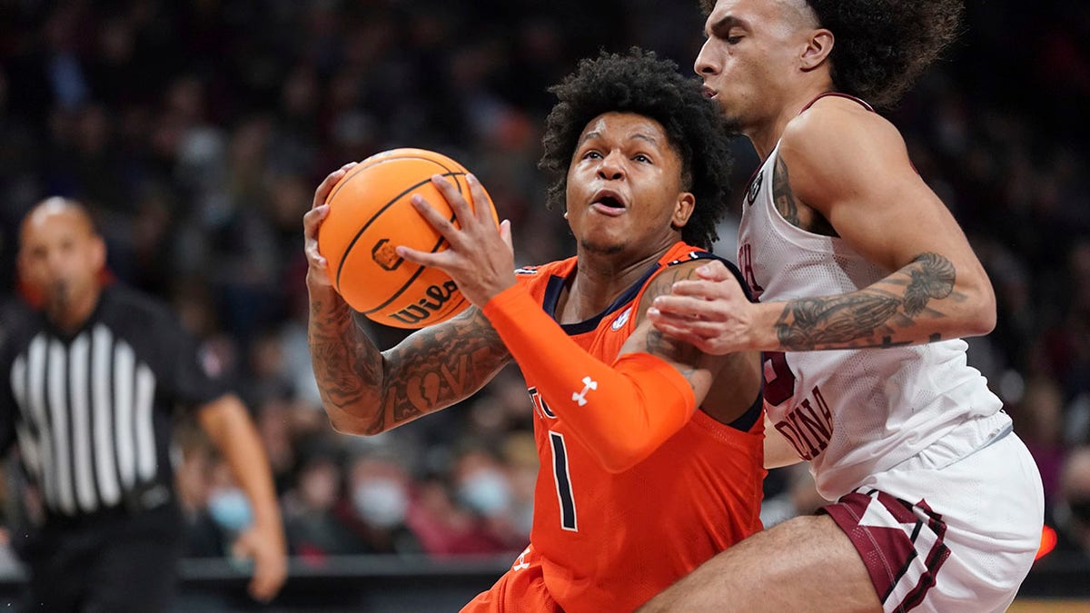 Auburn guard Wendell Green Jr. (1) drives to the hoop against South Carolina guard Devin Carter, right, during the first half of an NCAA college basketball game Tuesday, Jan. 4, 2022, in Columbia, S.C.