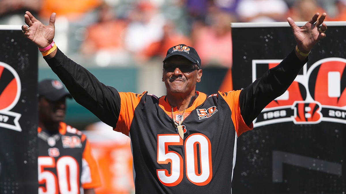 FILE - Former Cincinnati Bengals defensive end Ross Browner waves to the crowd during a halftime ceremony of an NFL football game against the Baltimore Ravens, Sunday, Sept. 10, 2017, in Cincinnati. Browner, a two-time All-American at Notre Dame and one of four brothers who played in the NFL, has died. He was 67. Browner's son, former NFL offensive lineman Max Starks, posted on Twitter early Wednesday morning, Jan. 5, 2022, that his father had died.