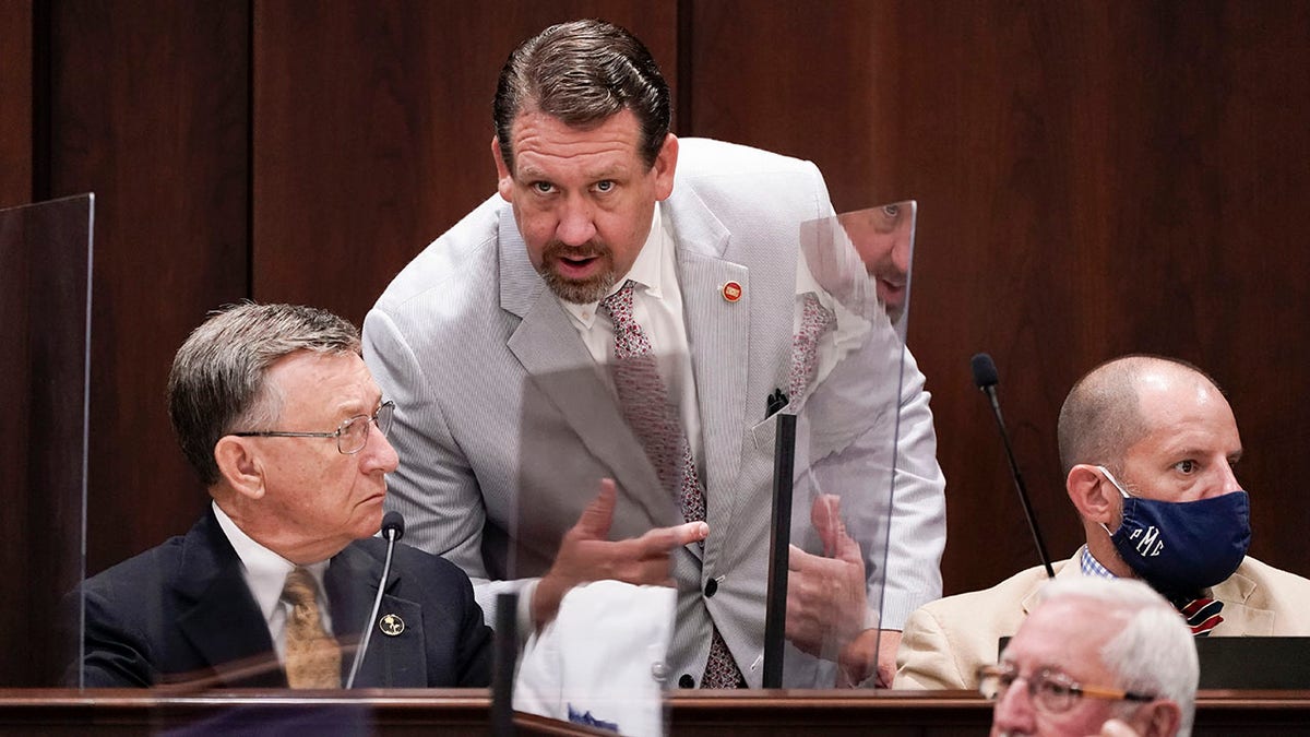 FILE - Rep. Jeremy Faison, R-Cosby, center, talks with Rep. Dan Howell, R-Georgetown, left, during a meeting, Aug. 11, 2020, in Nashville, Tenn. A top Tennessee House Republican lawmaker has apologized for losing his temper and being ejected from watching a high school basketball game after getting into a confrontation with a referee, including a brief gesture at pulling down the official's pants that is visible in video footage of the game. On Tuesday, Jan. 4, 2022 Rep. Jeremy Faison, 45, posted on Twitter that he "acted the fool tonight and lost my temper on a ref."