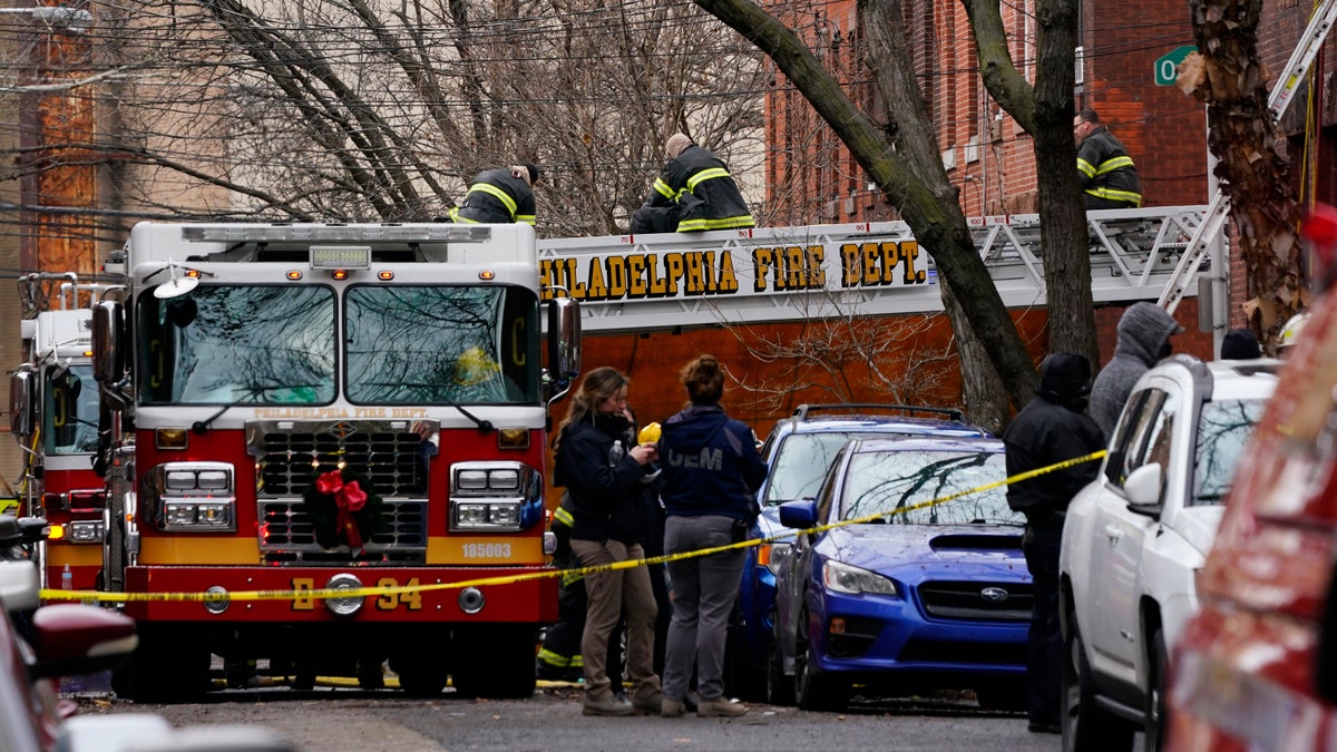 Philadelphia firefighters work at the scene of a deadly row house fire, Wednesday, Jan. 5, 2022, in the Fairmount neighborhood of Philadelphia. (AP Photo/Matt Rourke)
