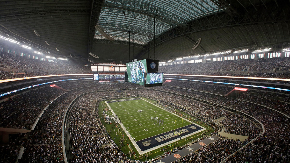 FILE - Fans watch at the start of an NFL football game inside AT&T Stadium between the New York Giants and Dallas Cowboys, Sunday, Sept. 8, 2013, in Arlington, Texas.
